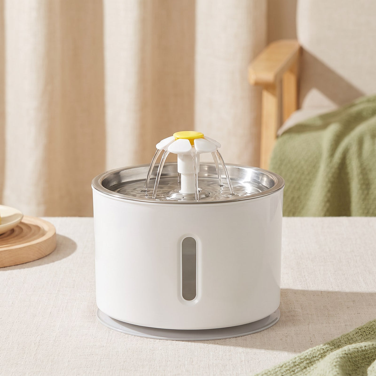 Automatic Cat Drinking Fountain on a warm neutral background